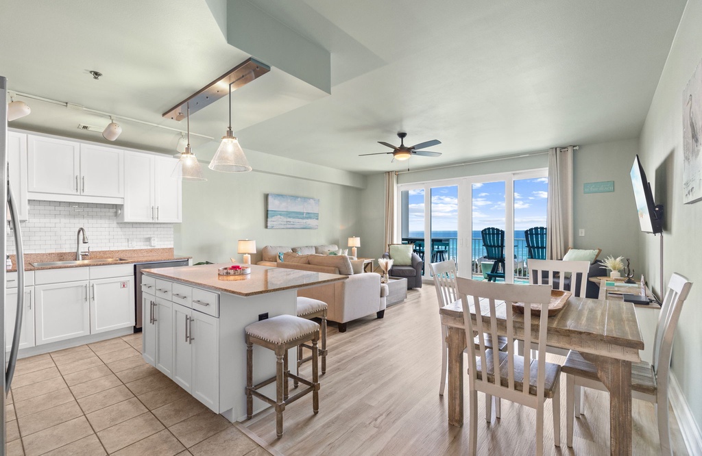 Your open-concept haven awaits with stunning sea views, modern kitchen island, and coastal décor creating the perfect beachside retreat.