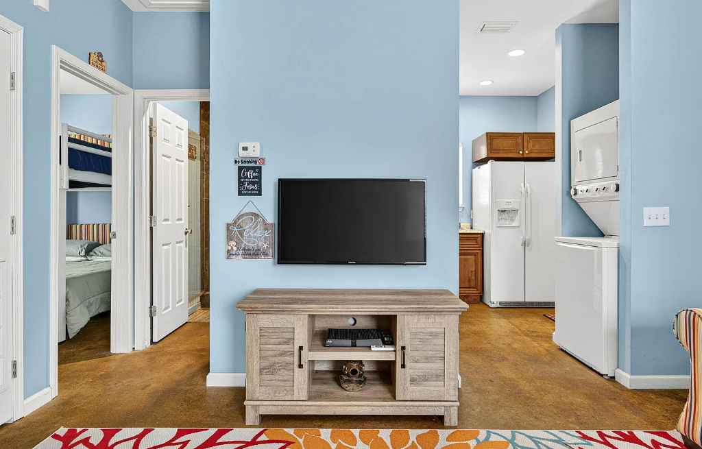 Your open living space blends comfort and convenience with a well-equipped kitchen, cozy TV area, and in-unit laundry—everything you need for a relaxing stay.