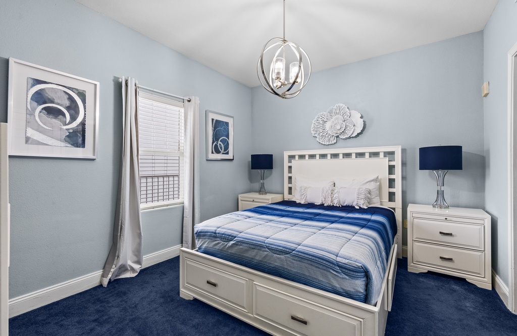 Sink into coastal calm in your serene bedroom, where soft blue walls and crisp white furniture create a peaceful haven for restful sleep.