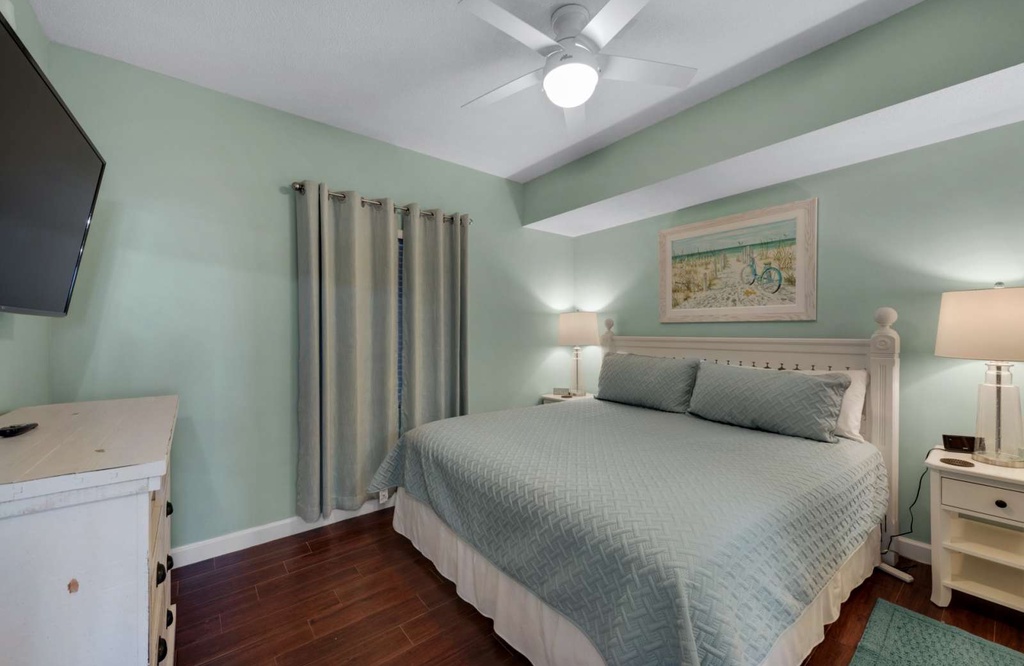 Cozy bedroom with a bed and soft green walls for a relaxing stay