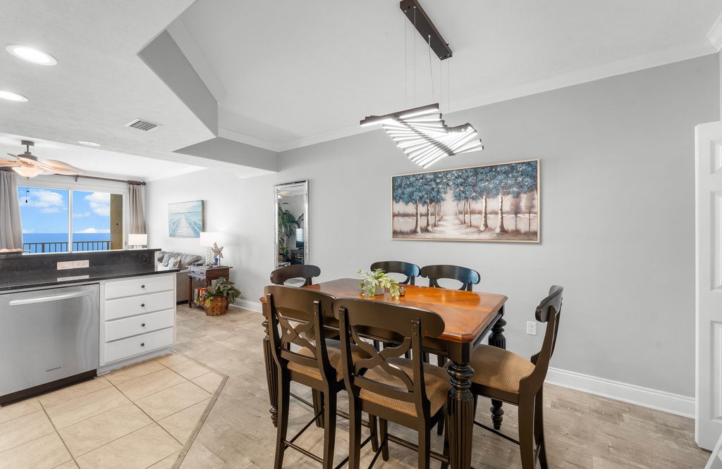 Dining area with seating for six and a view into the bright kitchen