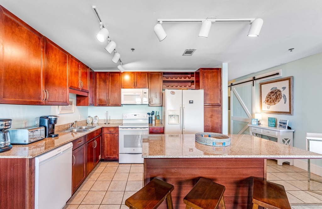 spacious kitchen with granite countertops and wooden cabinetry