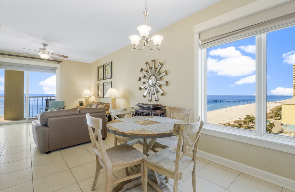 Relax in this bright dining area with ocean views and access to a comfortable living room.