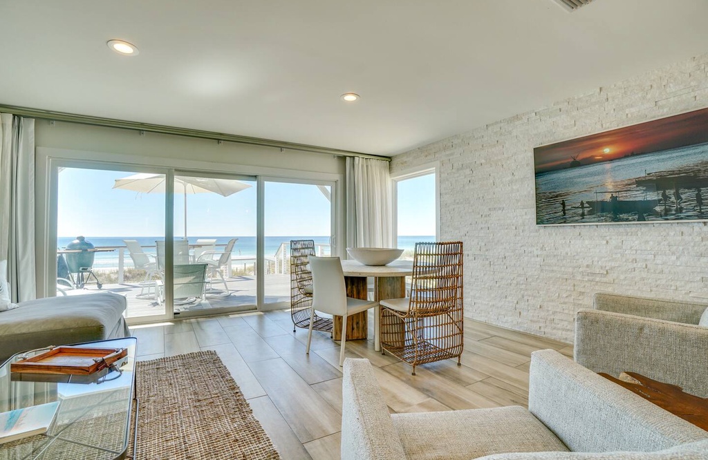 Step into your bright, beachfront retreat where ocean views greet you through expansive glass doors opening to your private terrace. Relax in the airy living space designed for coastal living and memorable seaside getaways.