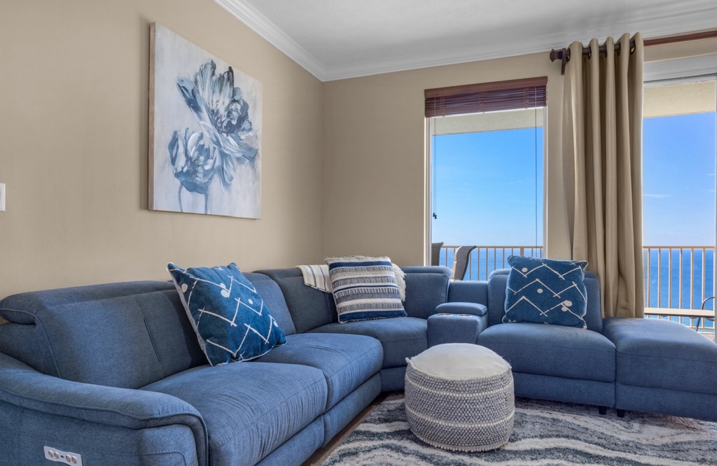 Sink into plush seating while soaking in stunning ocean views through floor-to-ceiling windows. This cozy retreat blends coastal elegance with comfort for your perfect seaside getaway.
