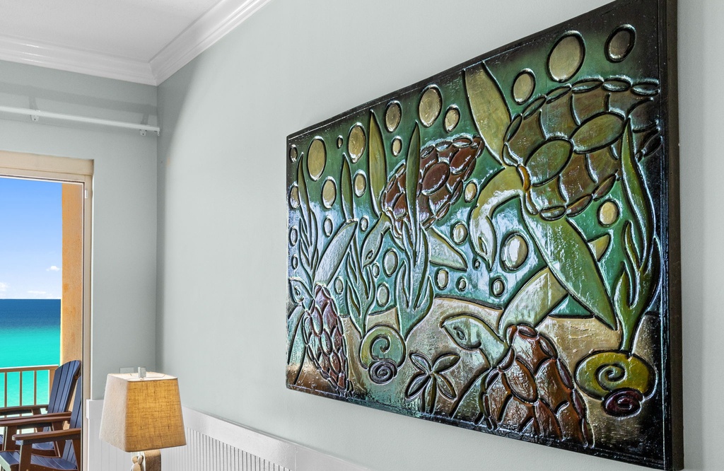 Relax in a calming space adorned with coastal-inspired art, where soft hues and tropical motifs set the tone for your beachside escape.