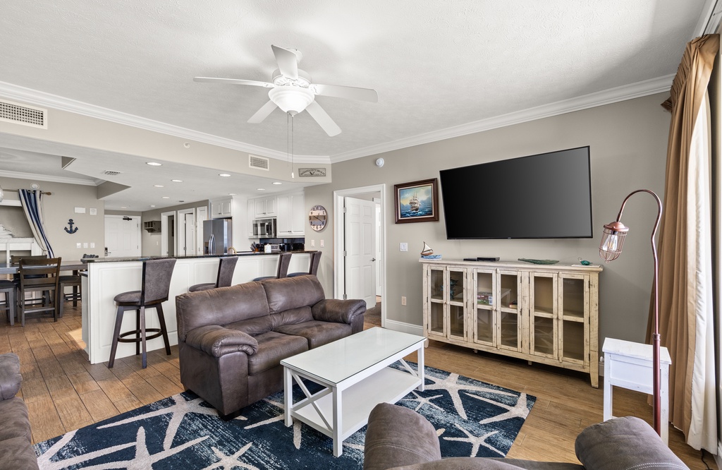 Relax in your spacious open-concept living area, where plush seating invites you to unwind after a day of adventure. The fully equipped kitchen flows seamlessly into the lounge, perfect for gathering with loved ones.