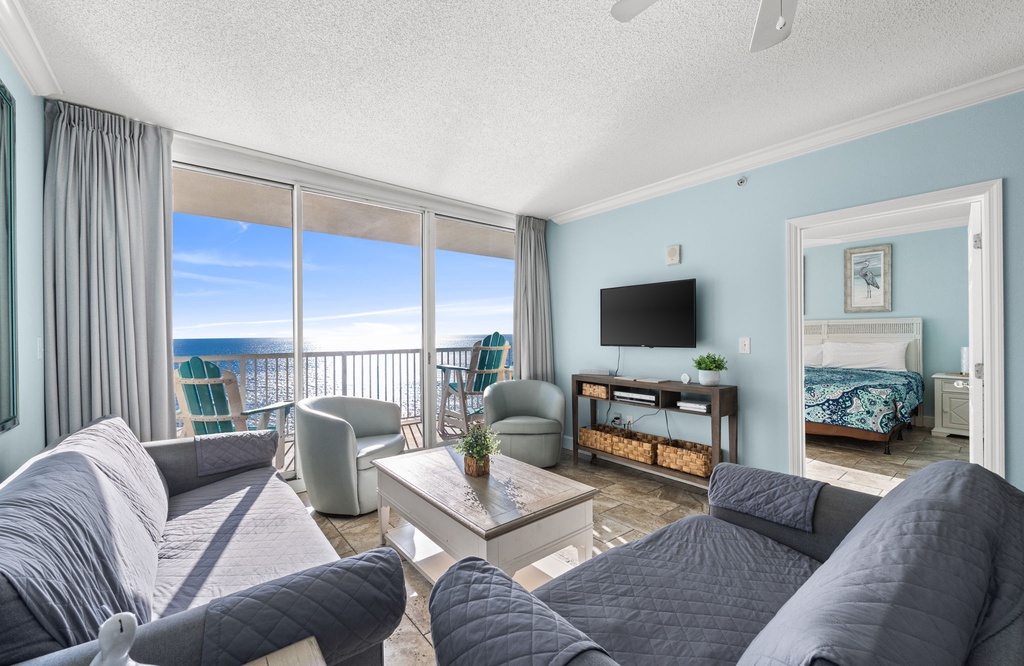 Relax in your bright oceanfront living room with stunning sea views and comfortable seating for the perfect beach getaway.
