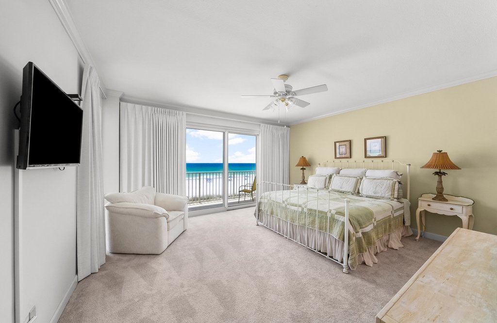 Relax in this spacious bedroom with ocean views and natural light.
