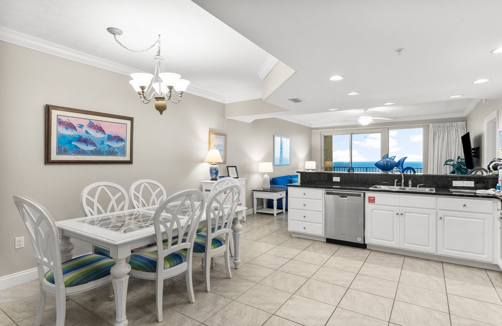 Open kitchen and dining area with ocean views and coastal decor.