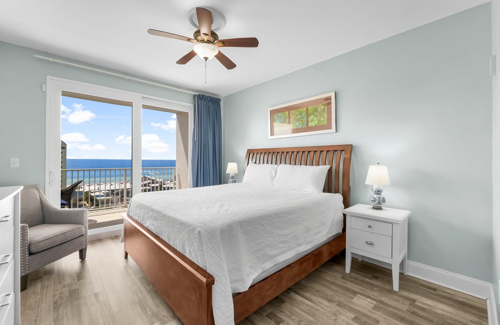 Relax in this bright bedroom with ocean views and modern coastal decor.