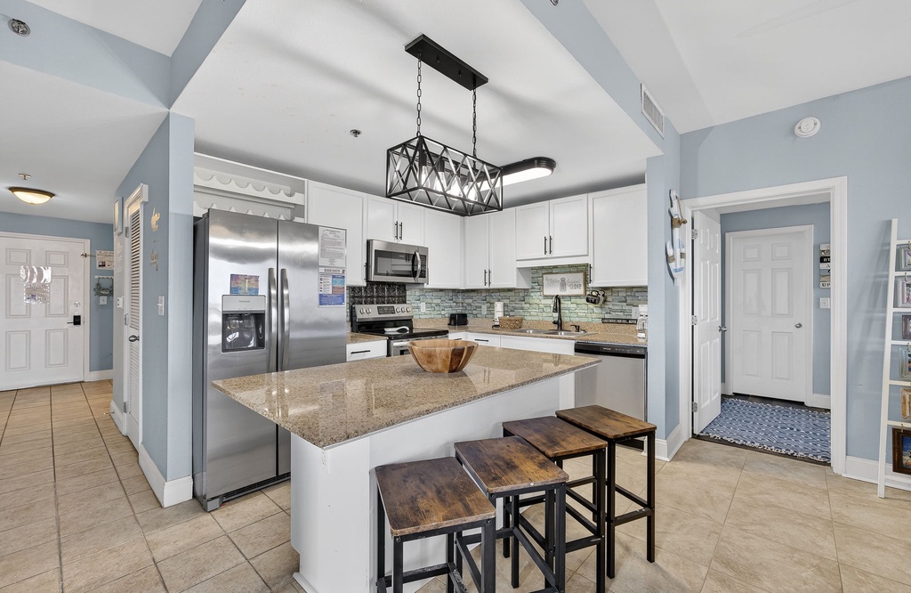 Modern kitchen with granite island and stainless steel appliances