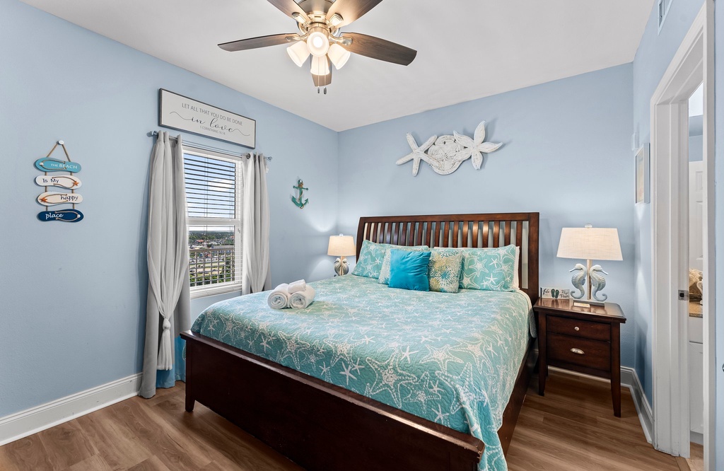 Relax in this coastal-themed bedroom with a bed and ocean-inspired decor.