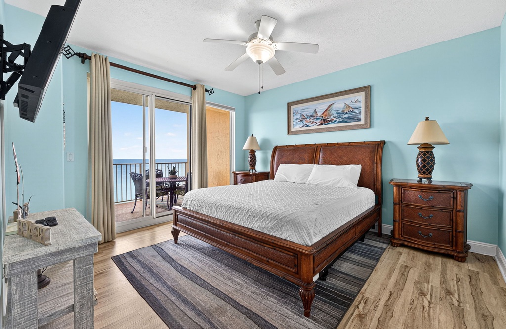 Relax in this coastal bedroom with a balcony view of the ocean.