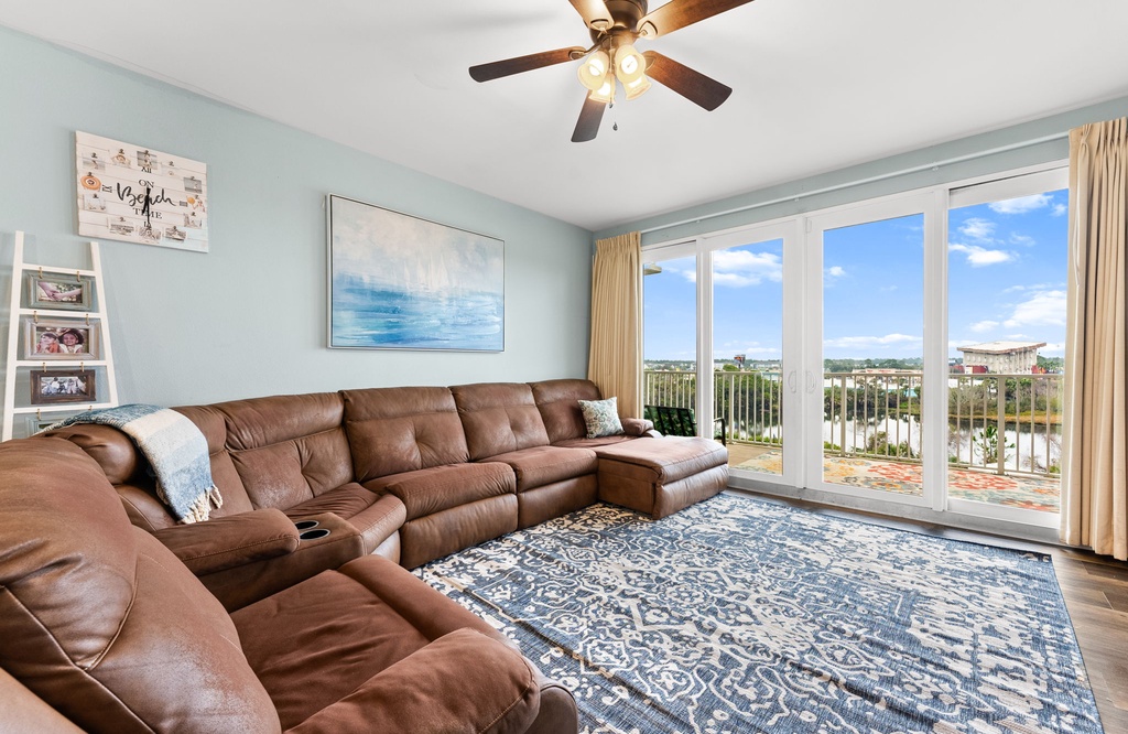 Sink into plush leather seating while enjoying stunning city views through floor-to-ceiling windows in your spacious living room retreat.