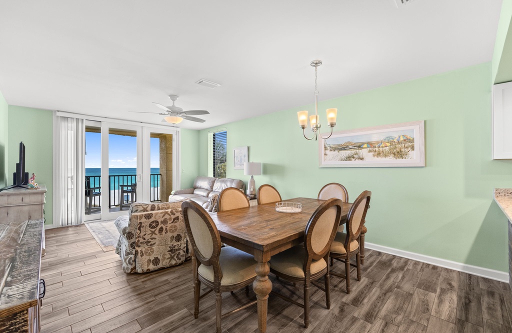 Gather around the elegant dining table w/ floor-to-ceiling windows framing stunning ocean views.