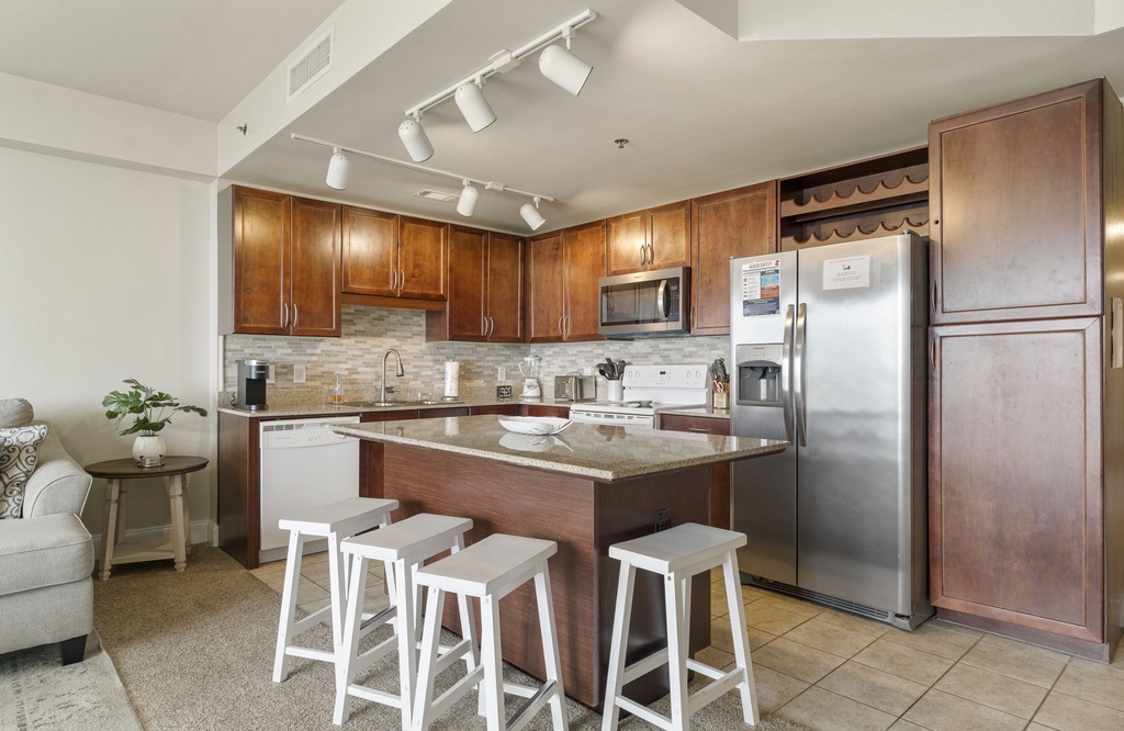 modern kitchen with granite island and stainless steel appliances