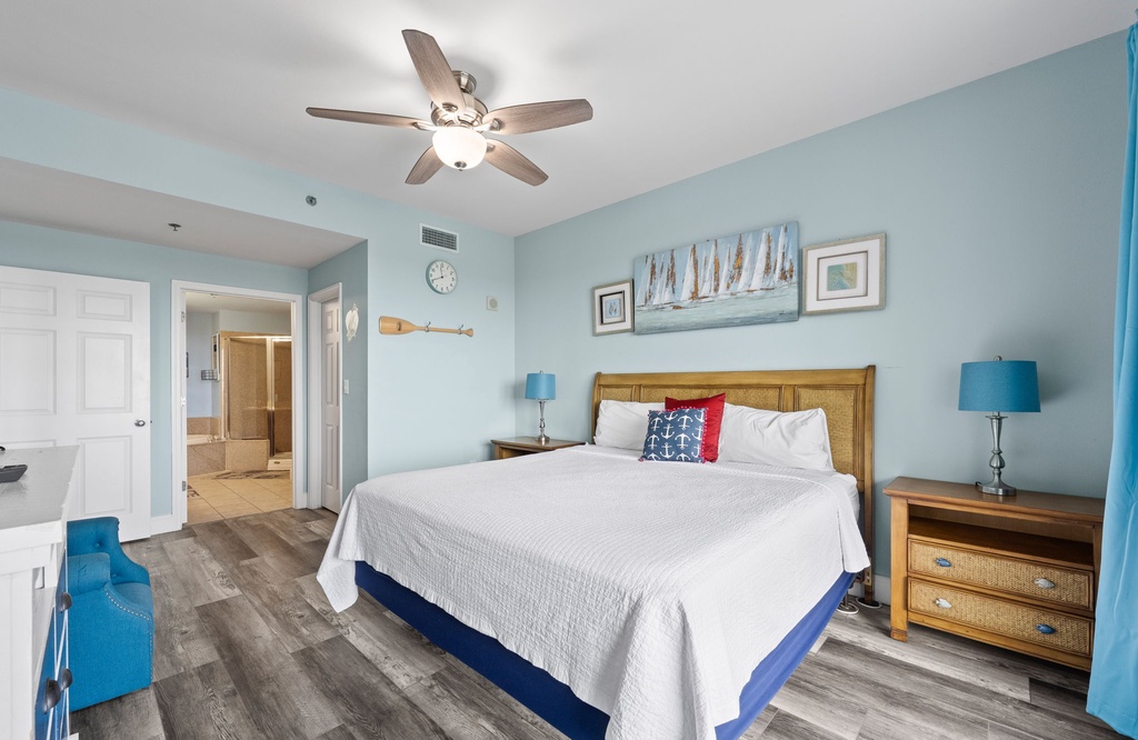 Relax in this coastal-inspired bedroom with a king-size bed and calming blue accents.