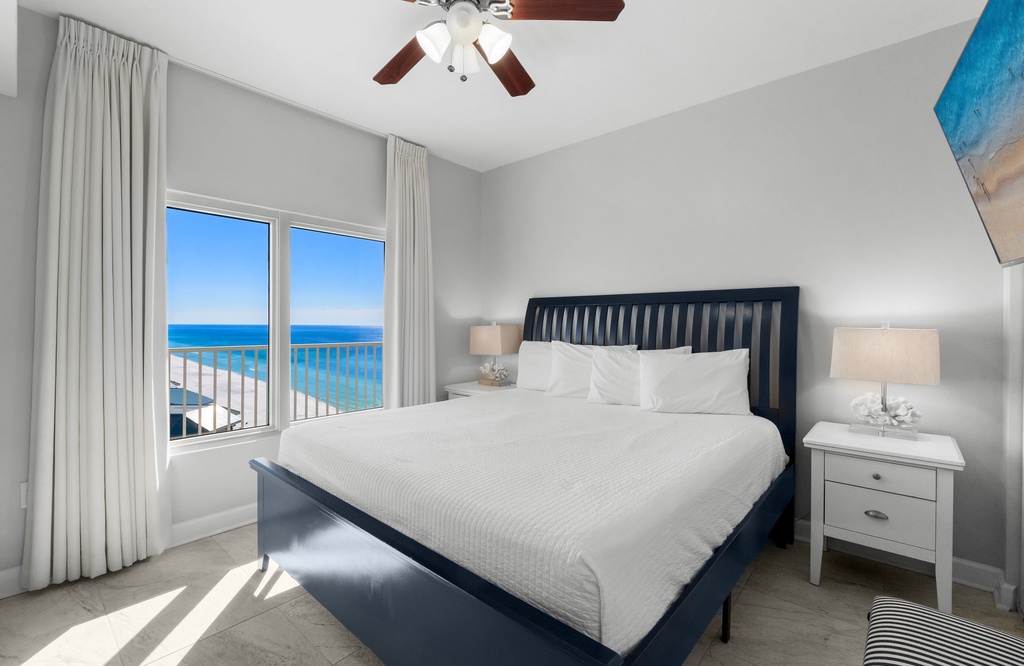Relax in this modern bedroom with ocean views through large windows.