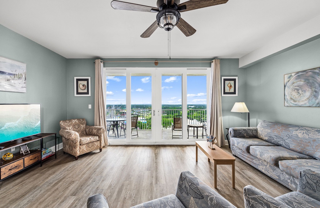 Unwind in your spacious living room where soft coastal colors meet comfort. Step out to your private balcony and soak in the sweeping scenery beyond.