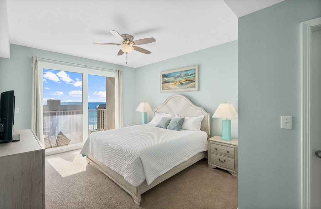 Relax in this coastal bedroom with ocean views and soft blue walls.
