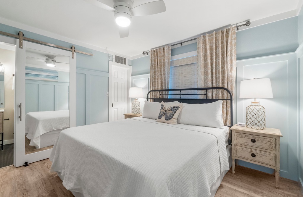 Cozy bedroom with a metal bed frame and mirrored closet doors