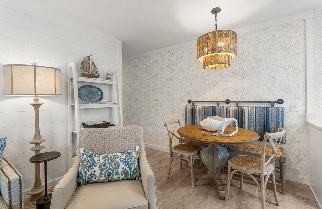 Cozy dining nook with rustic wooden table and striped bench seating