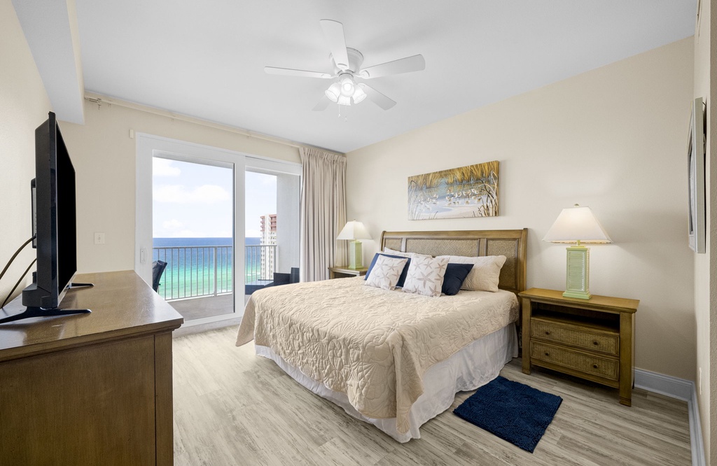 Relax in this bright bedroom with ocean views and modern coastal decor.