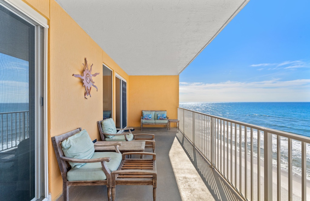 Relax on the spacious balcony with ocean views and comfortable seating.