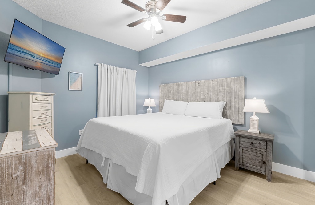 Relax in this modern bedroom with calming blue walls and soft lighting.