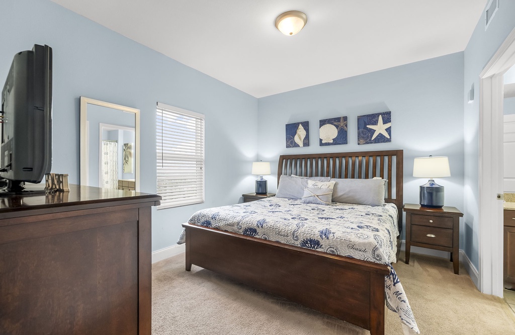 Relax in this coastal-themed bedroom with a bed and soft blue walls.