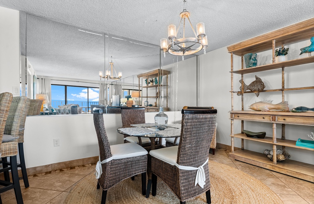 Dining area with wicker chairs and ocean views in a coastal-style setting