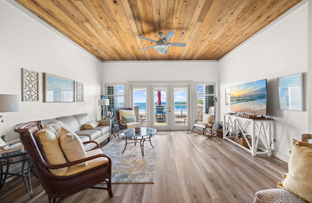 Relax in your bright living space with stunning wood-beamed ceilings and ocean views through French doors.