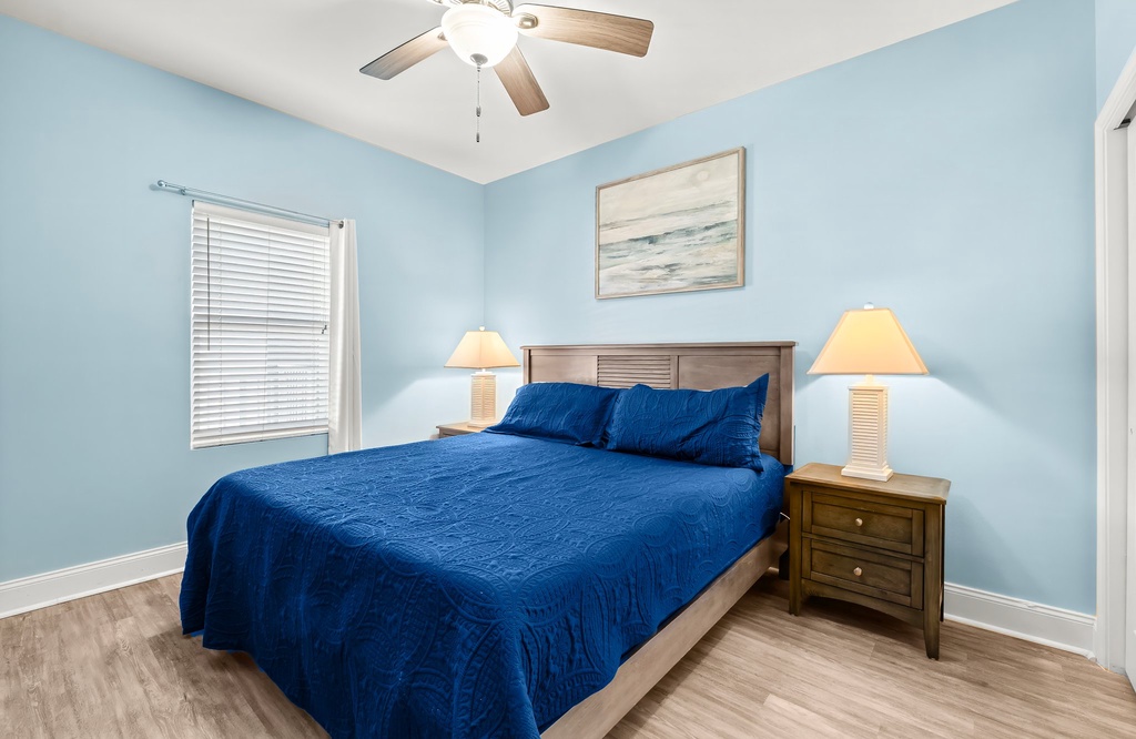 Cozy bedroom with a blue accent wall and natural lighting
