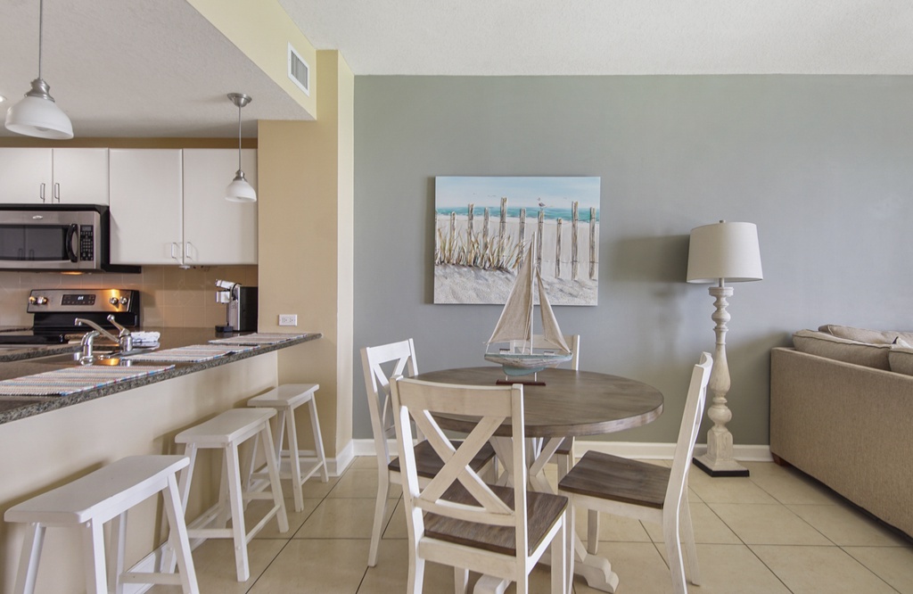 Modern dining area with coastal decor and an open kitchen layout