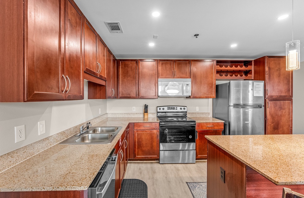 Modern kitchen with stainless steel appliances and granite countertops