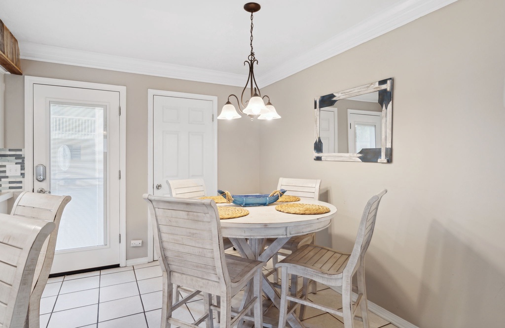 Cozy dining area with a round table and natural light from the glass door