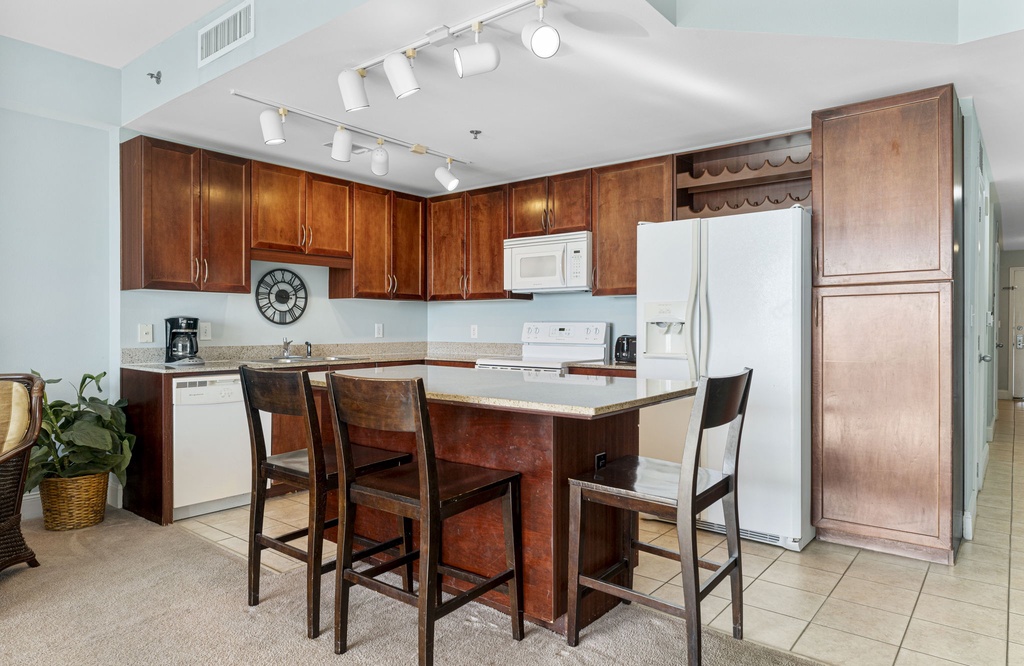 Modern kitchen with wooden cabinetry and a central island for casual dining.