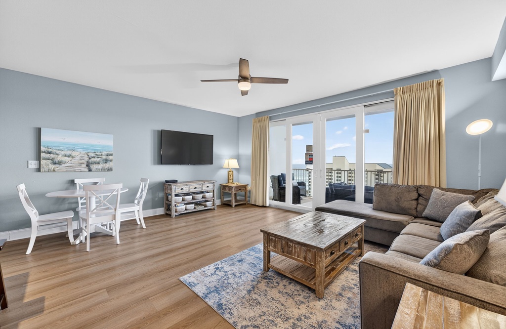 Unwind in your spacious living room with plush sectional seating, modern amenities, and sweeping city views from your private balcony.