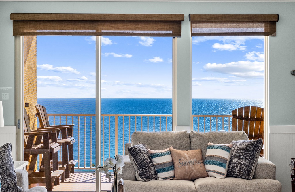 Picture yourself unwinding on this cozy sofa, gazing through floor-to-ceiling windows at the sparkling ocean stretching to the horizon—your private balcony awaits for morning coffee or sunset moments.