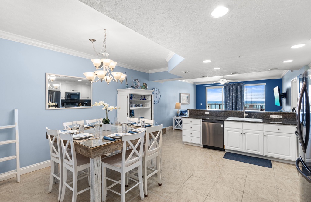 Open dining and kitchen area with ocean views and modern coastal decor