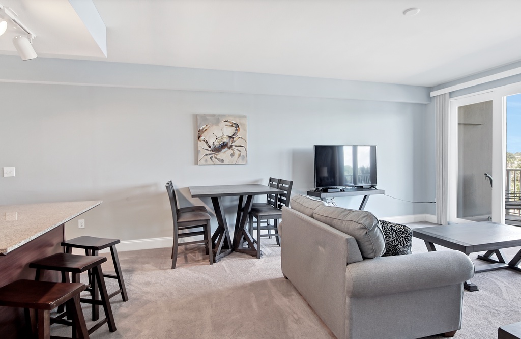 Open living and dining area with modern furnishings and natural light.