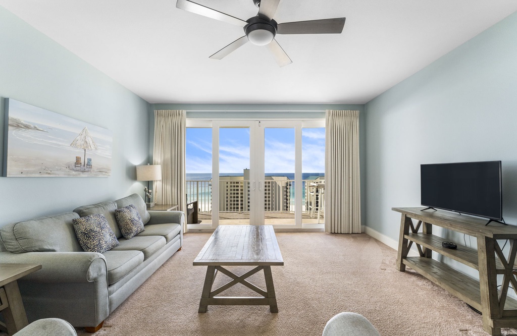 Relax in this coastal living room with ocean views through large glass doors.