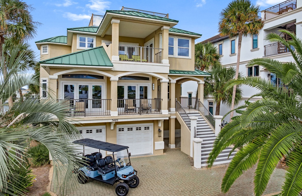 A spacious coastal retreat surrounded by swaying palms. The elegant architecture features multiple balconies and covered porches where you can soak in the sea breeze and tropical ambiance.