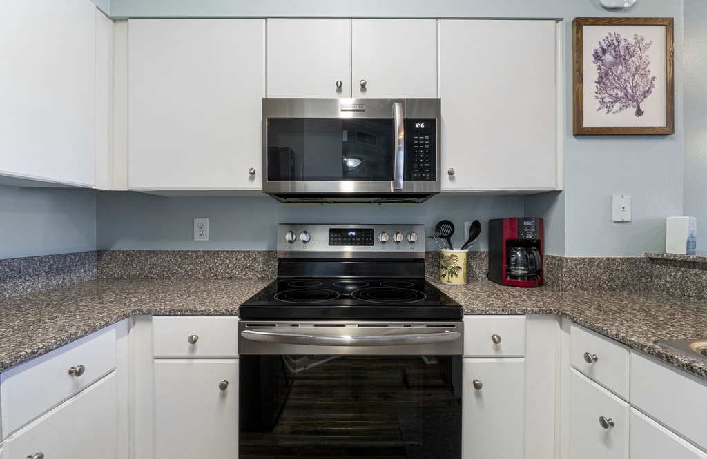 Modern kitchen with stainless steel appliances and granite countertops