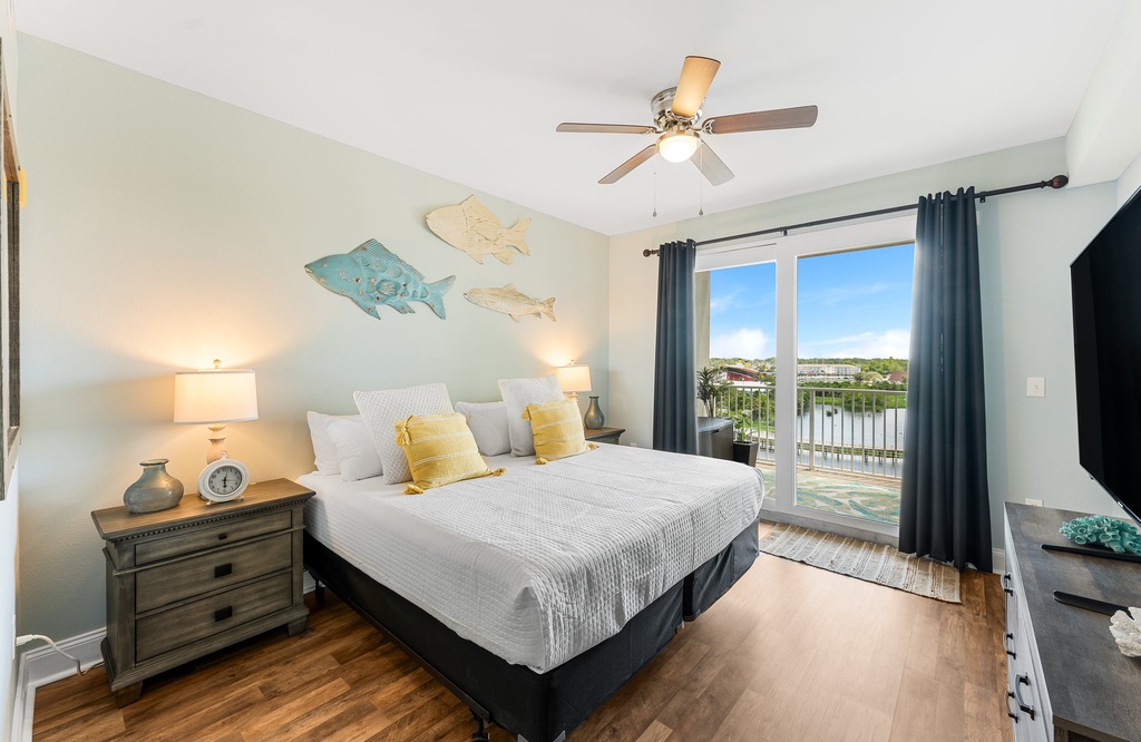 Relax in this coastal-inspired bedroom with a balcony overlooking the water.