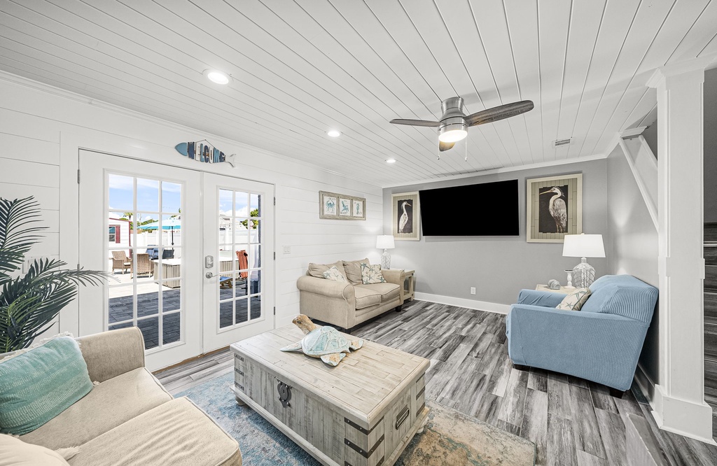 Relax in this coastal-style living room with ample seating and natural light.