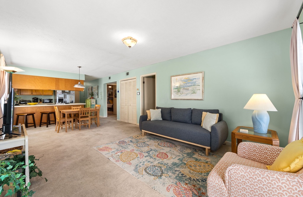 Your spacious open-concept living area flows seamlessly from comfortable seating to fully equipped kitchen, perfect for relaxing and entertaining.