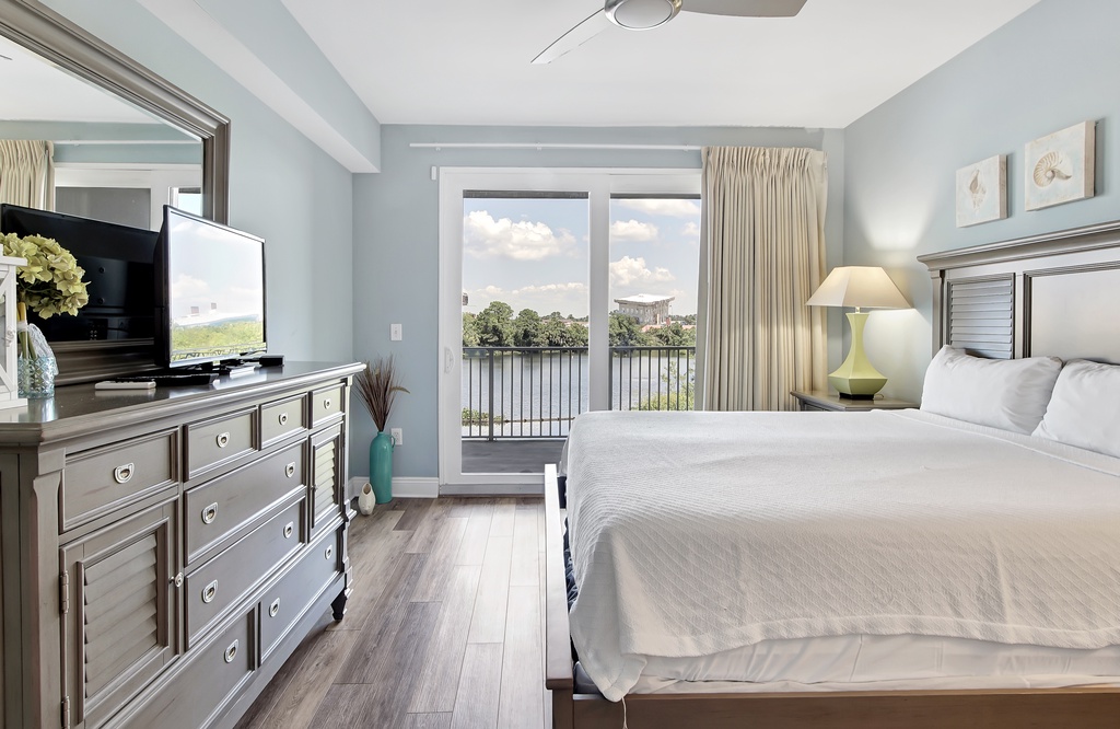 Relax in this modern bedroom with a balcony overlooking the water.