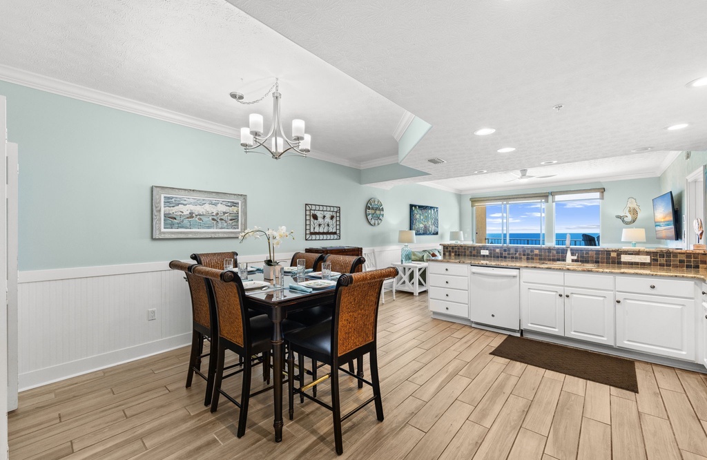 Open kitchen and dining area with ocean views and coastal decor